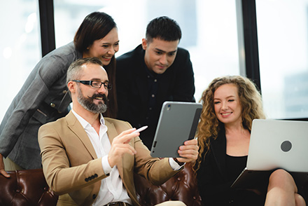 Collaborative team discussing IT outsourcing vs. managed services. 